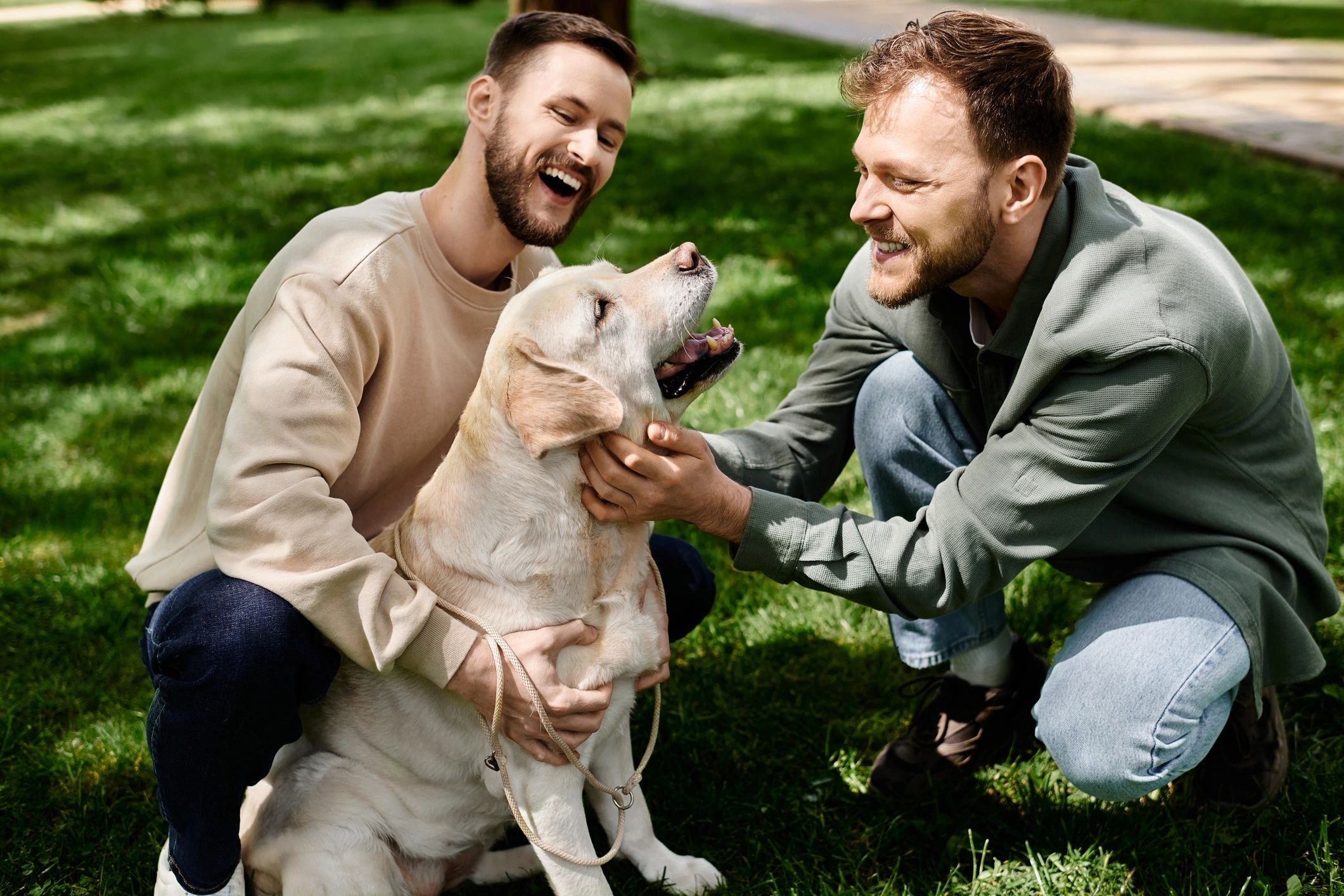 Happy dog owner playing with a dog in a sunny park