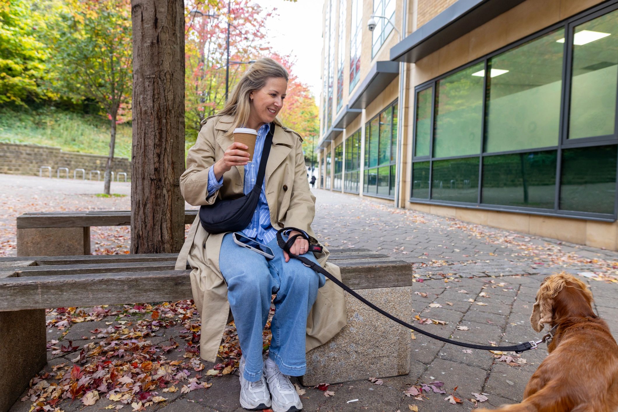 Dog owner relaxing outdoors with a well-behaved dog